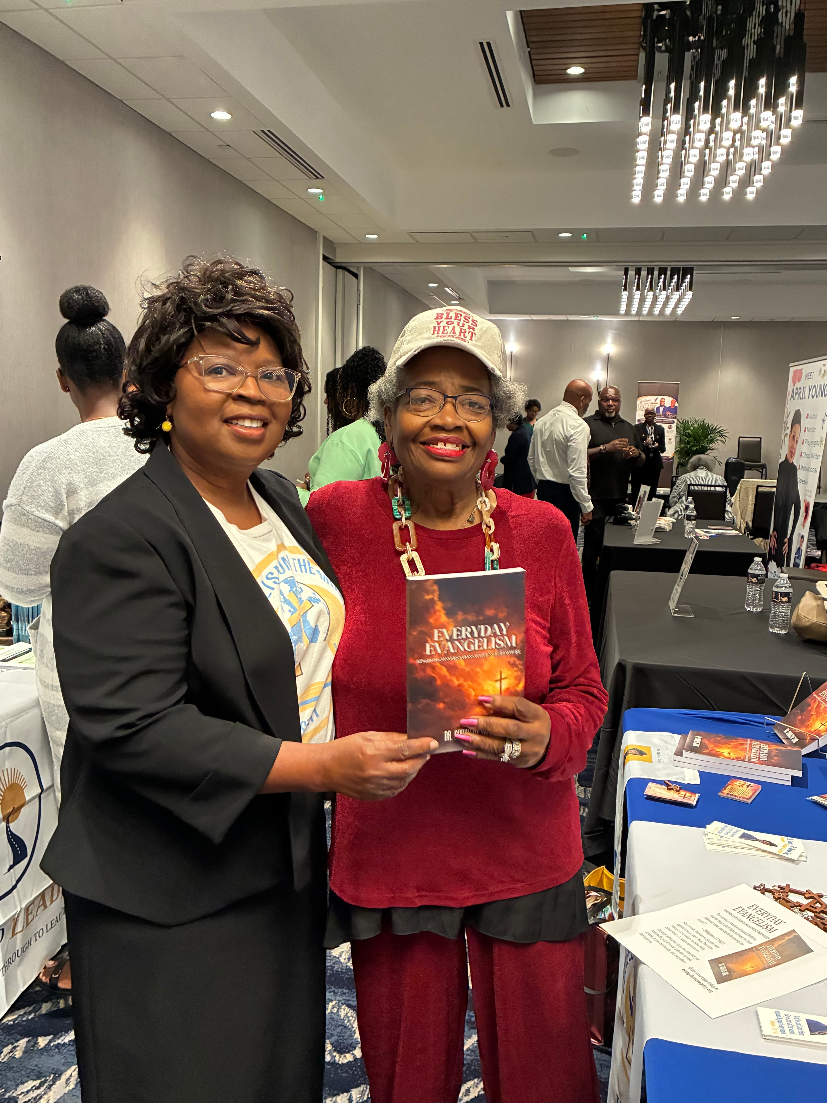 Dr. Charlene Long with a customer holding Everyday Evangelism at Legacy Literary Tour 2026