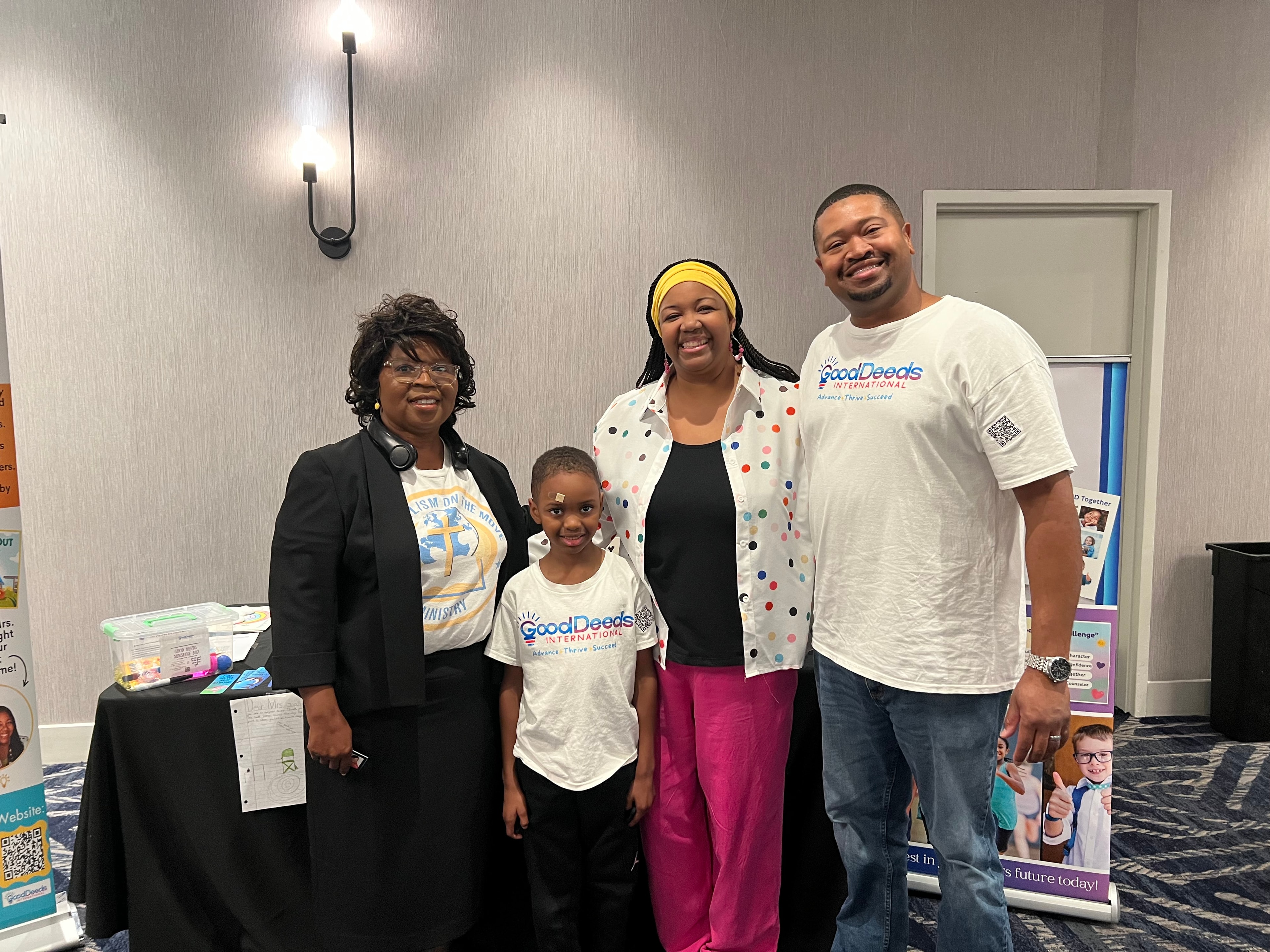 Dr. Charlene Long with a family at the Legacy Literary Tour 2026 — Good Deeds International