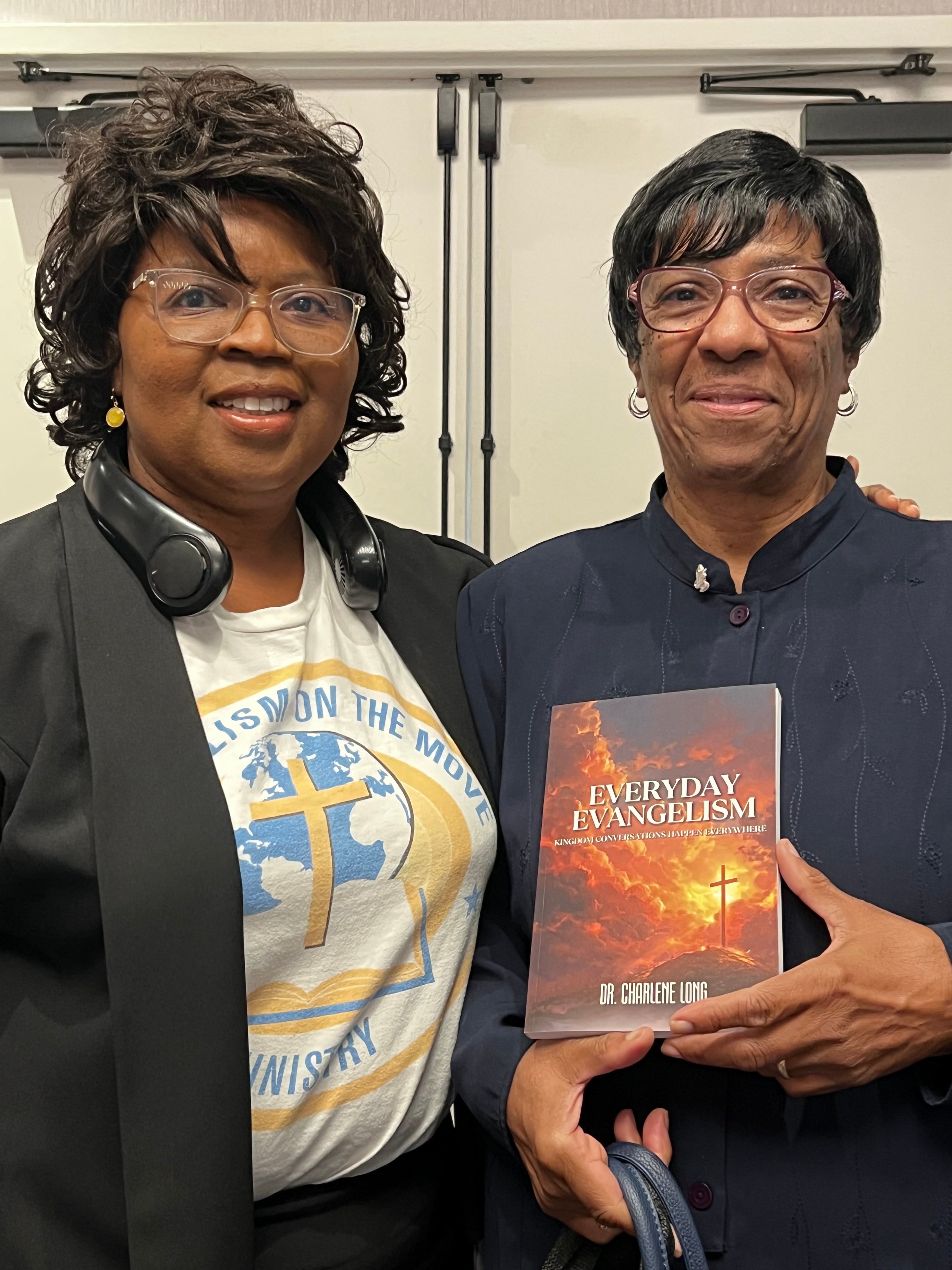 Customer holding Everyday Evangelism with Dr. Charlene Long at Legacy Literary Tour 2026